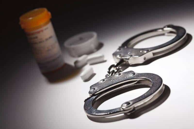 handcuffs next to drugs