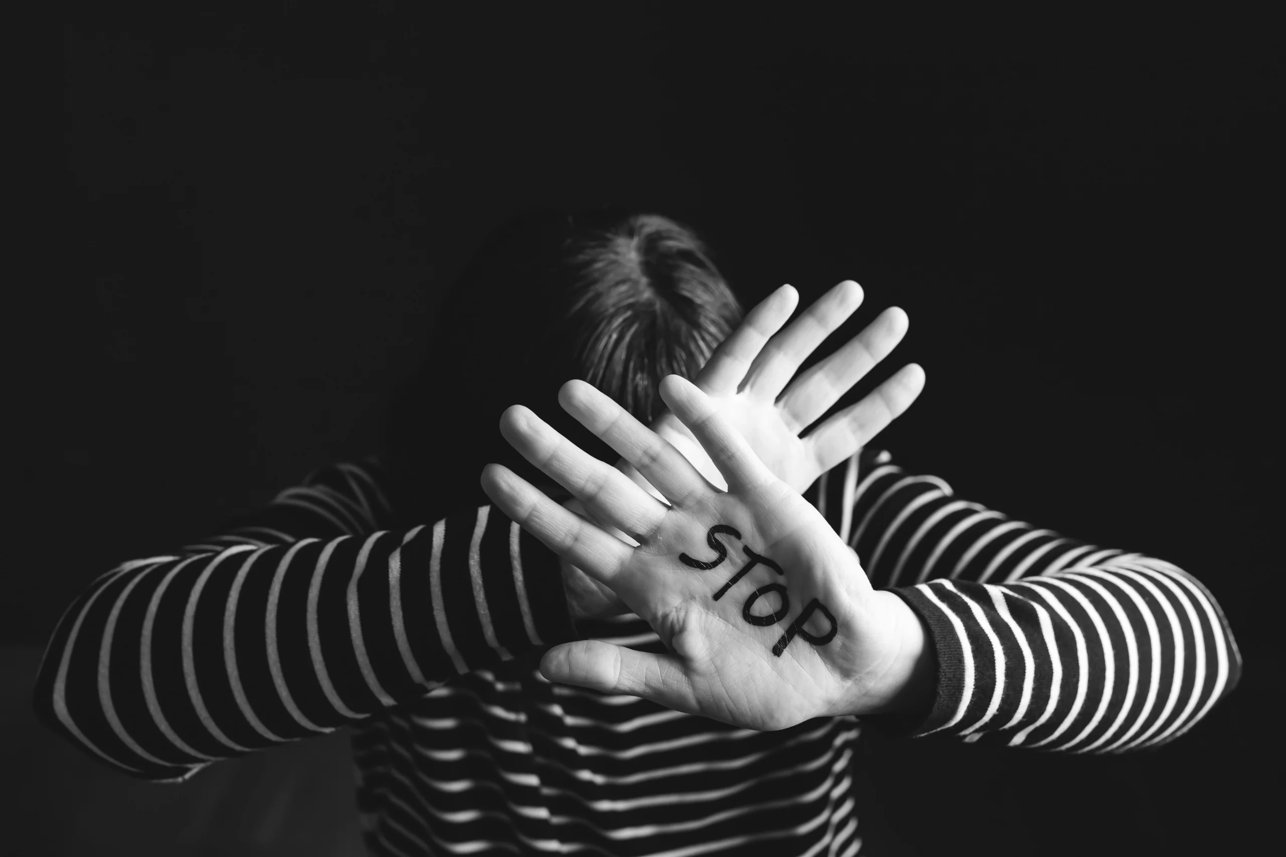 person with the word stop on their hand to prevent domestic violence